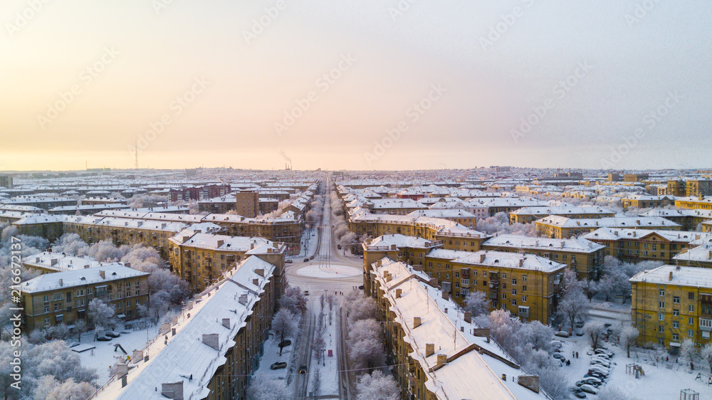 Drone photo of Magnitogorsk city in the winter evening, building of the fifties, Russia
