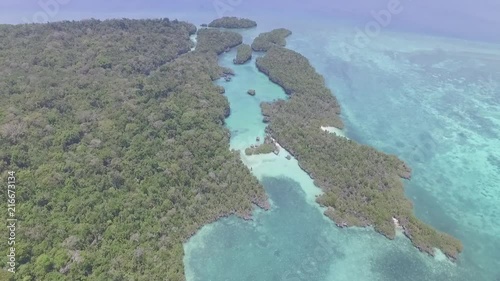 Drone shot revealing secluded Bair lagoon surrounded by trees - Kei islands photo