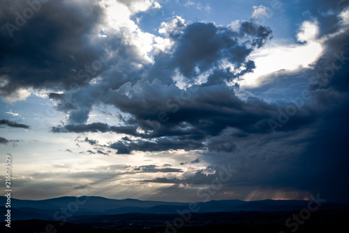 Beautiful clouds with sun penetrating them during sunset.