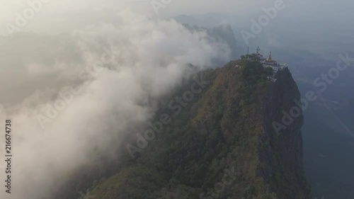 Drone shot: Mt Zwegabin during sunrise partly covered in clouds photo