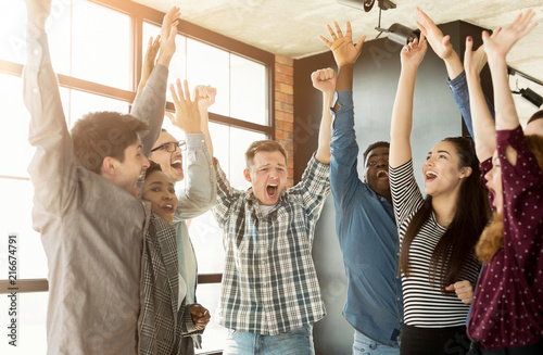 Young business team enjoying success at office photo