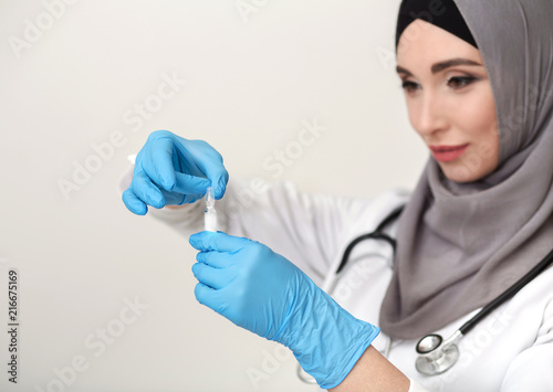 Arab female doctor on white studio background