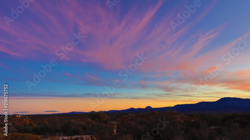 Spectacular sunrise in the Kagga Kamma Nature Reserve in South Africa with pink streaky clouds in the sky