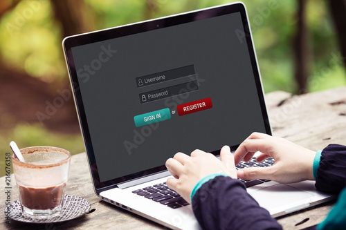 Woman working and sign in membership username password on laptop / computer at the park / outdoor