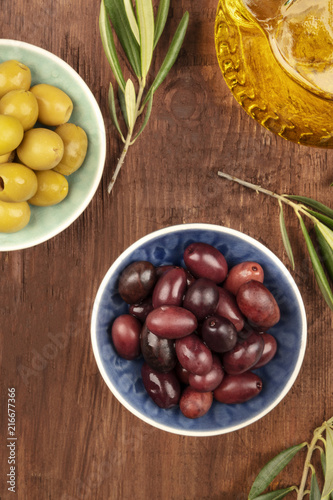 Overhead photo of various olives in bowls with copy space