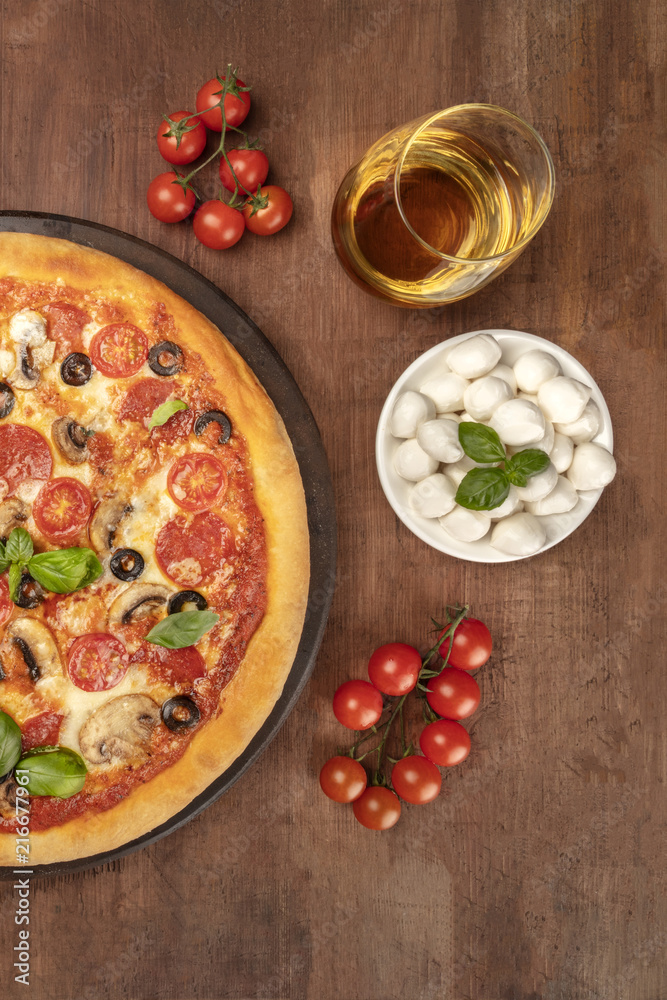 Pepperoni pizza with white wine, ingredients, and copy space