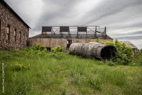 Abandoned Industrial Site. Mining machinery abandoned in a field at the Quincy Mine in the Keweenaw National Historical Park in Calumet, Michigan