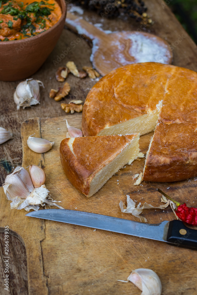 Fototapeta premium Suluguni cheese piece. Pickled or brined traditional Georgian smocked cheese from the Samegrelo region made of cow milk. Popular diary product in Georgia