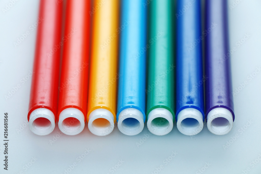 Multi-colored bright felt-tip pens on a white background Multi-colored bright felt-tip pens on a white background
