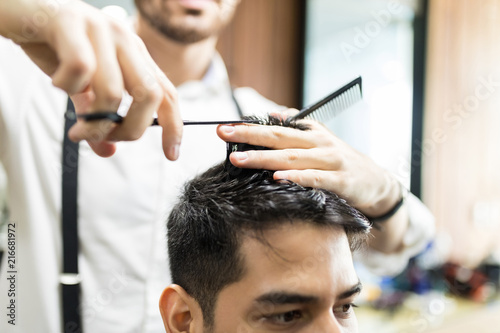 Barber's Hands Using Scissors To Cut Customer's Hair