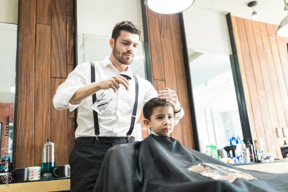 Hairdresser Sprinkles Water On Customer's Hair In Barber Shop Hairdresser Sprinkles Water On Customer's Hair In Barber Shop