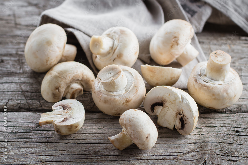 Fresh mushrooms champignons on a wooden background. Autumn Harvest Food Vegetarian Vegetable Fresh mushrooms champignons on a wooden background. Autumn Harvest Food Vegetarian Vegetable