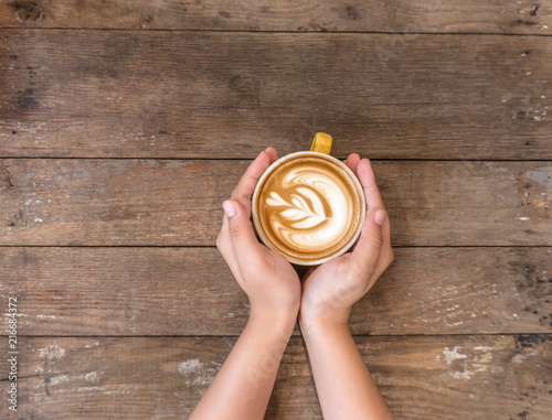 coffee cup in hand on coffee shop.