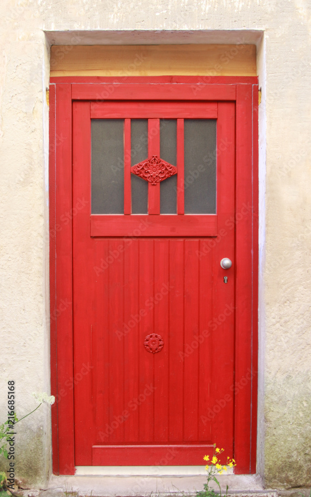 red entrance door with decorative elements