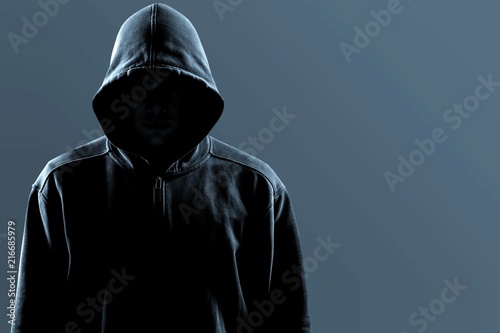 Thief in black clothes on grey background photo