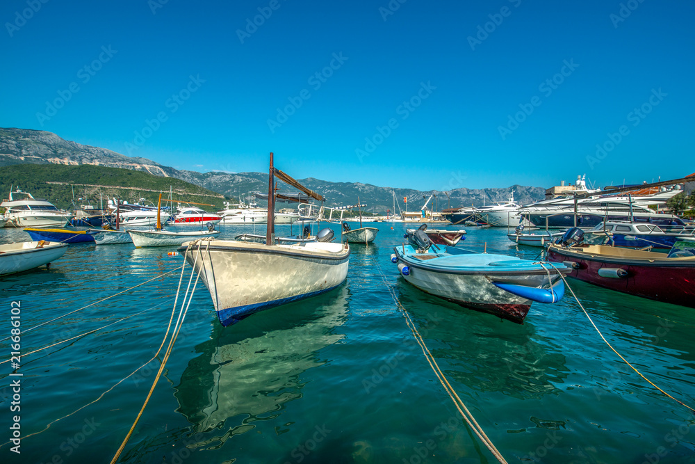 małe drewniane łodzie przycumowane w zatoce na wyspie, Budva - obrazy, fototapety, plakaty 