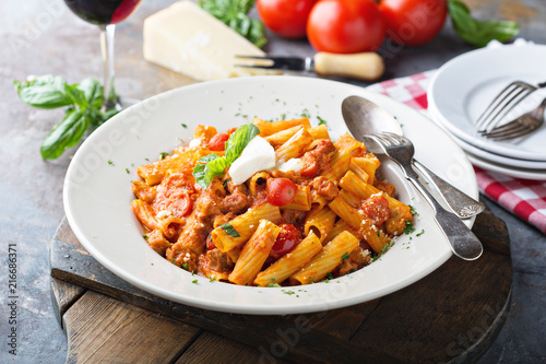 Rigatoni bolognese with fresh mozarella and basil photo