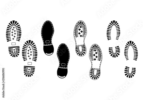 Footprints. Black silhouettes of soles of male shoes on a white background.Flat vector. photo