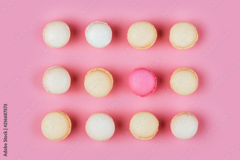 Top view of colorful macaron or macaroon on pink background.