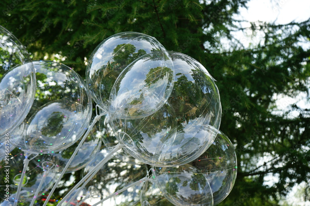 The balls are white transparent on a background of green spruce. The balls are white transparent on a background of green spruce.