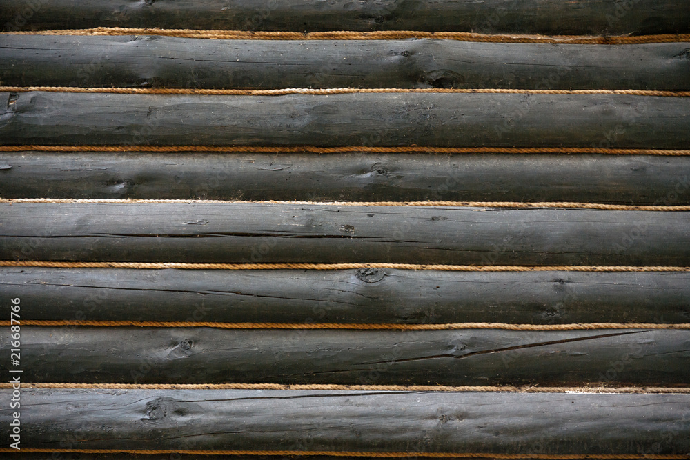 Wooden wall made of timber decorated with ropes Wooden wall made of timber decorated with ropes