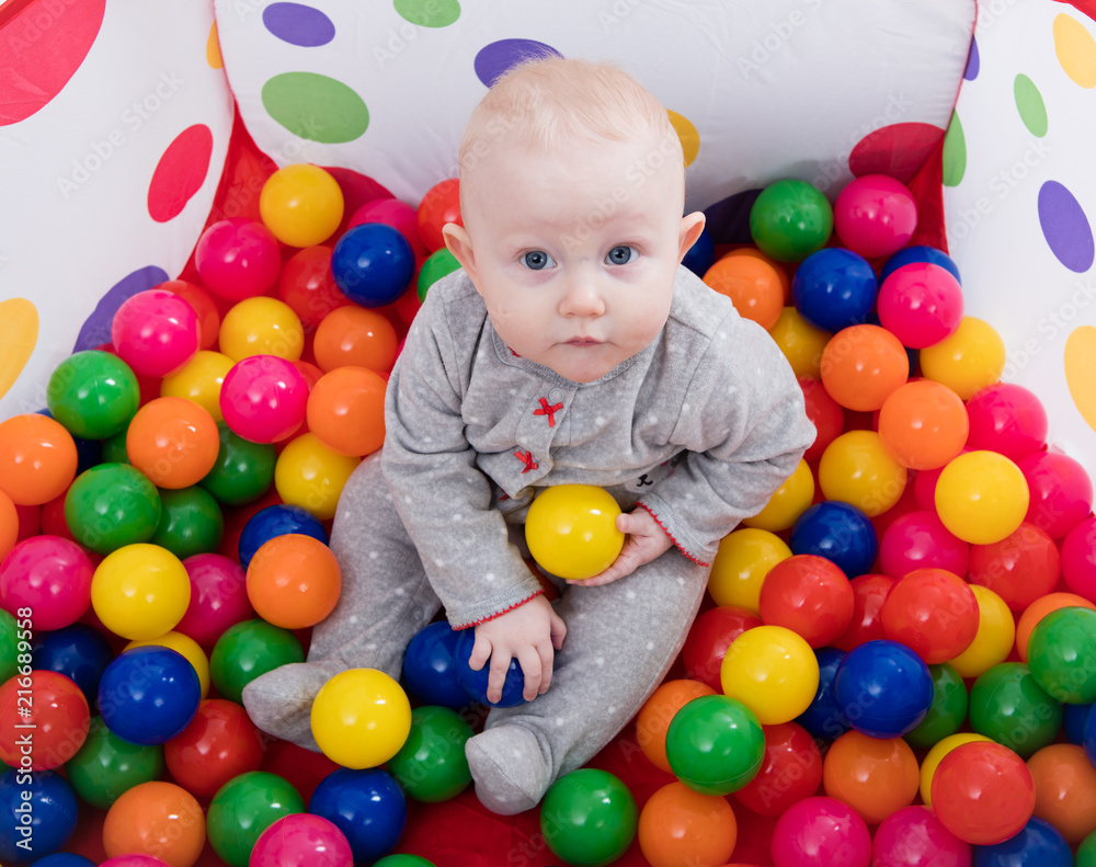 Baby playing with balls in the playground Baby playing with balls in the playground