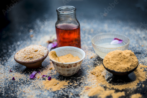 Oats face mask or face pack of Avena sativa i.e. Mulpani mitti or multani mitti or fuller's earth, rose water,lemon juice and powdered oats,on wooden surface.It is used in spa to clean oily skin. photo