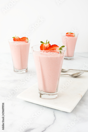 Three Glasses filled with Strawberry Mousse on Marble Board