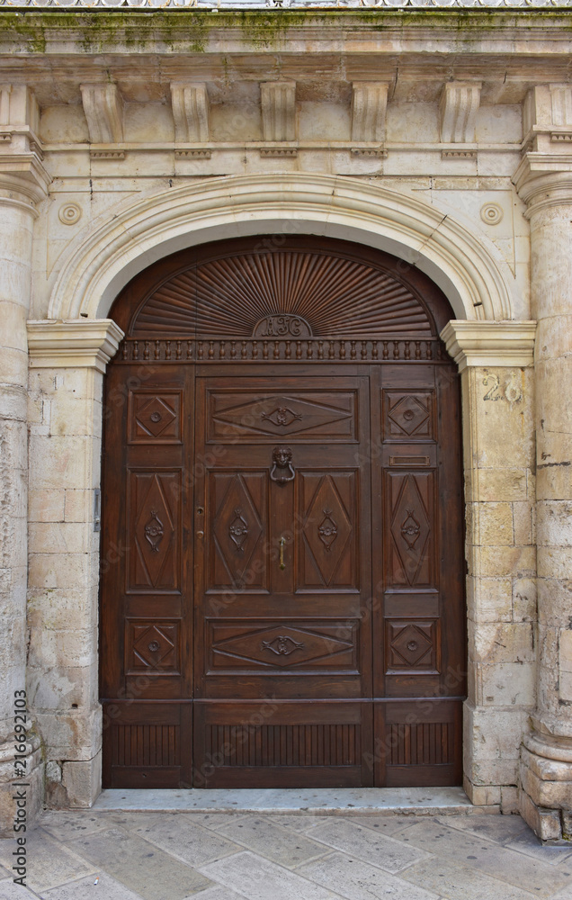 Italy, Puglia region, Martina Franca, medieval historical center in the middle of Valle d'Itria. View and detail of an ancient gate.