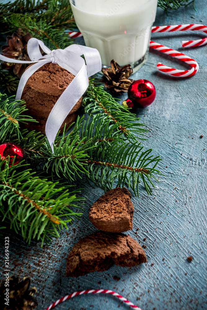 Festive Christmas greeting card background with natural Fir Spruce branches, chocolate cookies, milk glass. Christmas treat for Santa Claus, light blue background copy space Festive Christmas greeting card background with natural Fir Spruce branches, chocolate cookies, milk glass. Christmas treat for Santa Claus, light blue background copy space
