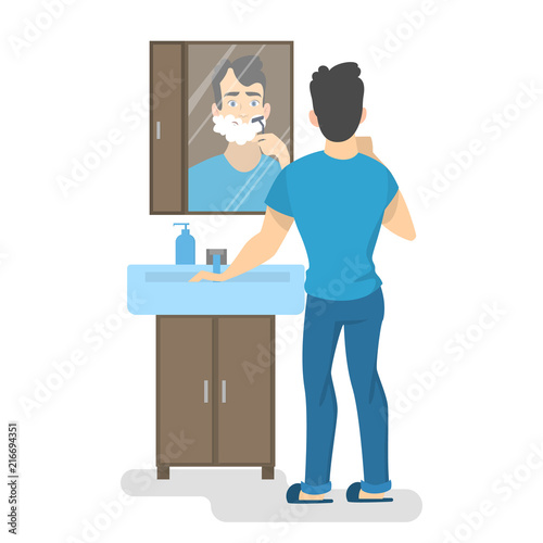 Man shaving his beard in bathroom