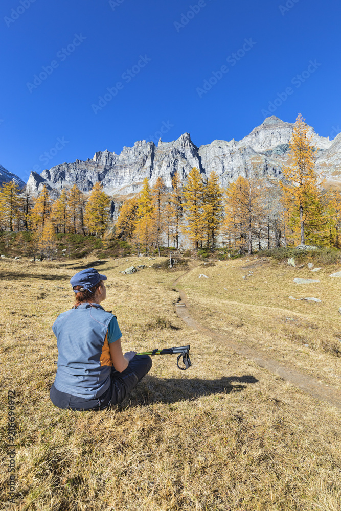A girl is relaxing near the Nero Lake in the Alpe Veglia and Alpe Devero Natural Park (Buscagna Valley, Alpe Devero, Baceno, Verbano Cusio Ossola province, Piedmont, Italy, Europe) A girl is relaxing near the Nero Lake in the Alpe Veglia and Alpe Devero Natural Park (Buscagna Valley, Alpe Devero, Baceno, Verbano Cusio Ossola province, Piedmont, Italy, Europe)