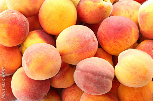 Fresh sweet peaches as background