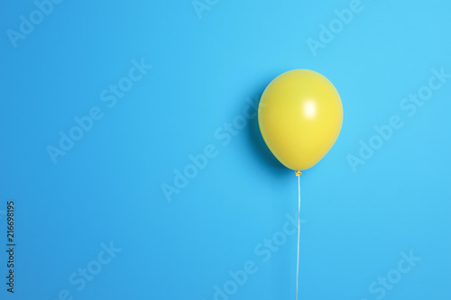 Fotobehang Yellow balloon on color background. Celebration time