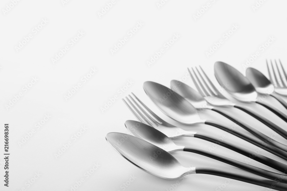 Forks and spoons on white background. New cutlery Forks and spoons on white background. New cutlery