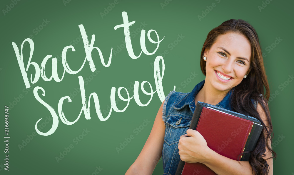 Back To School Written On Chalk Board Behind Mixed Race Young Girl Student Holding Books Back To School Written On Chalk Board Behind Mixed Race Young Girl Student Holding Books