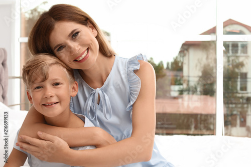 Portrait of mother and son in bedroom