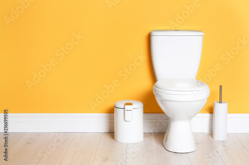 New ceramic toilet bowl in modern bathroom with space for text