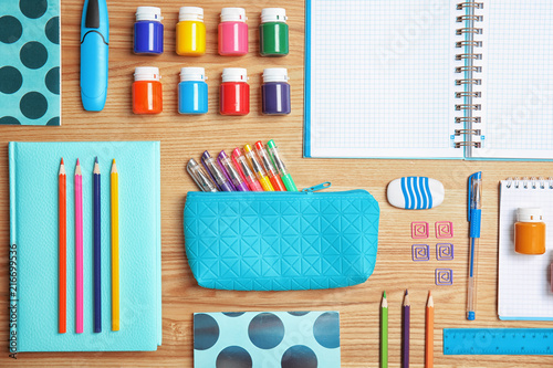 Different school stationery on wooden background, flat lay