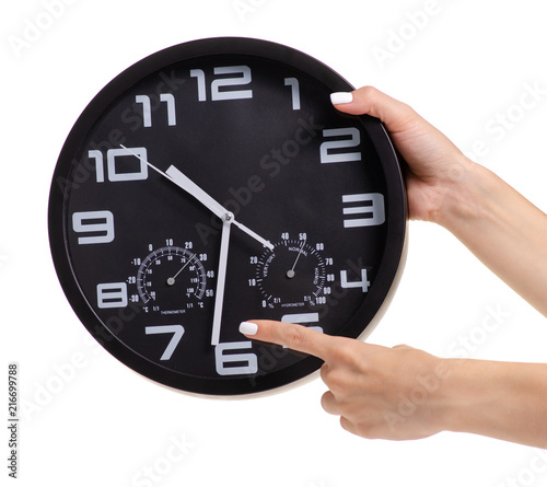 Wall black clock in hand on white background isolation