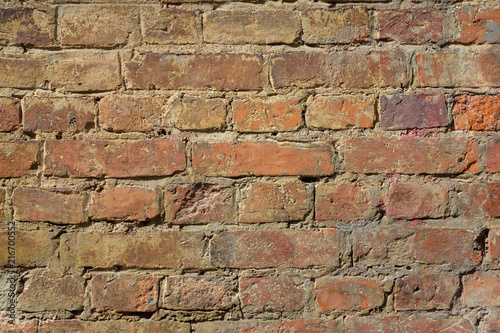Old rough brown bricks wall texture background.
