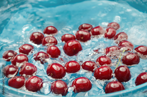 Ripe red cherry in clean water, washed