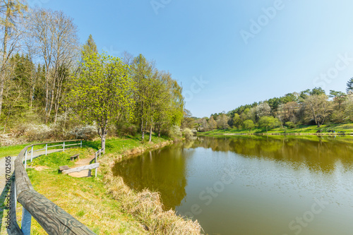 Lake Stausee in the hills at the German town of Gerolstein surrounded by mountain walls and trees and is used as fishing water for breeding and catching trout