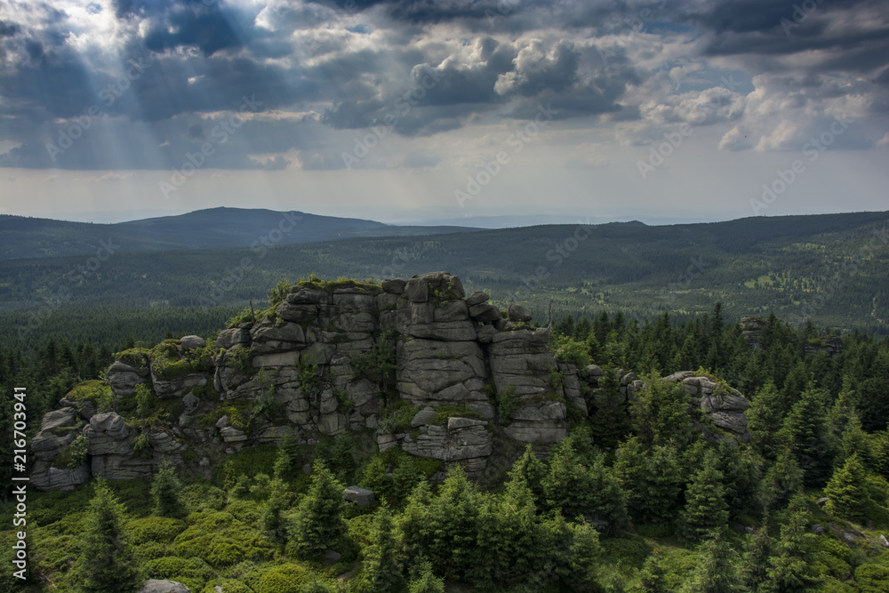 Obraz premium The rocky mountains landscape. View from the rock hill to landscape. Amazing and dramatic clouds and sky.