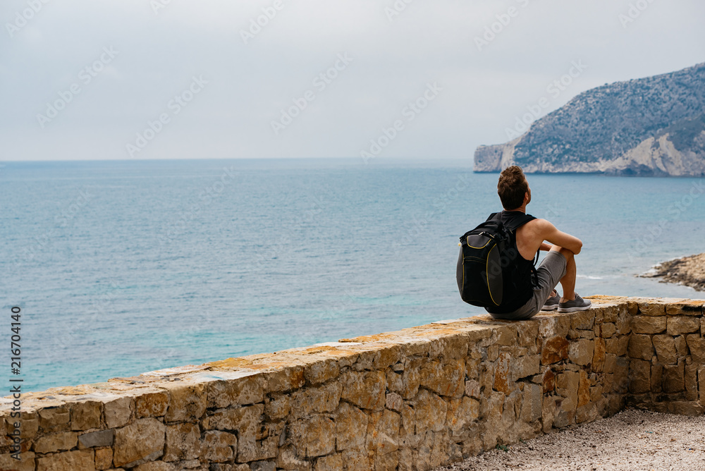 Man sitting contemplating the sea view Man sitting contemplating the sea view