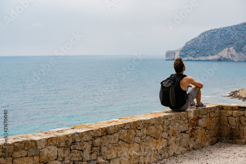 Man sitting contemplating the sea view
