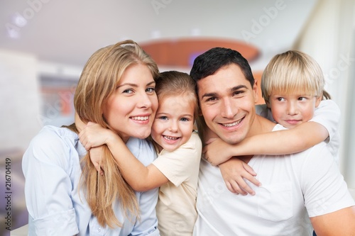 Beautiful smiling family sitting at sofa