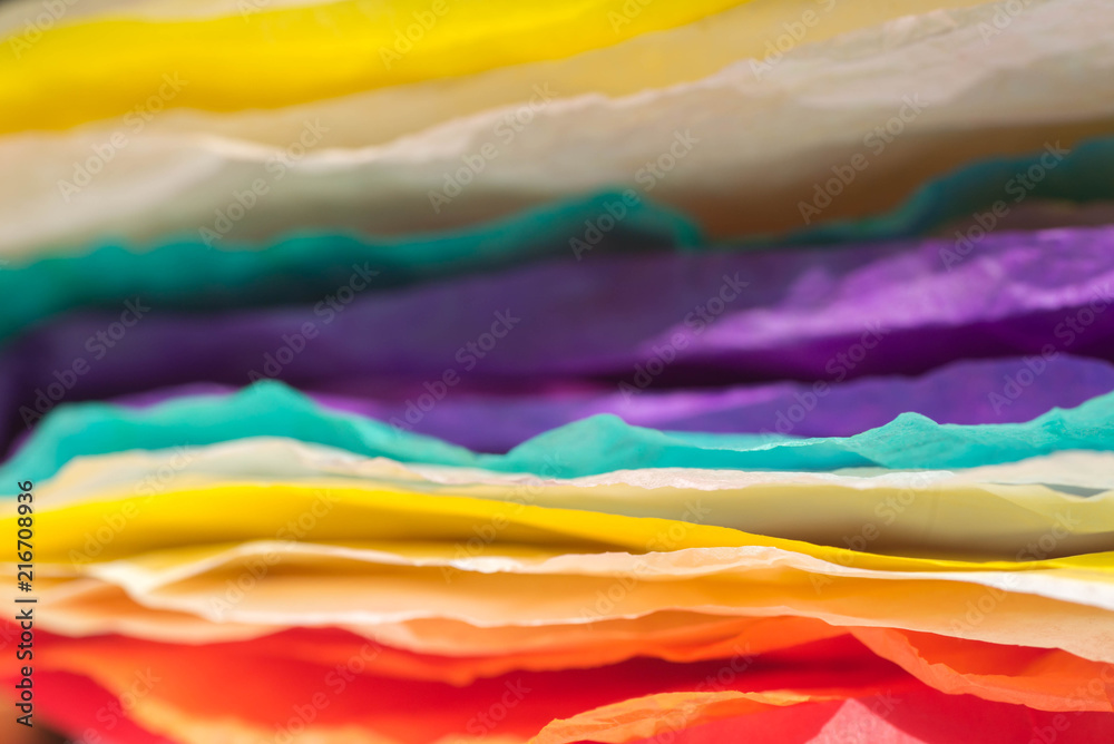 stack of multicolored creased paper tissue macro