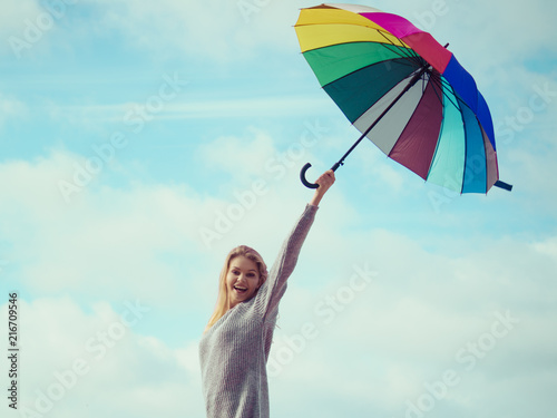 Happy woman holding umbrella