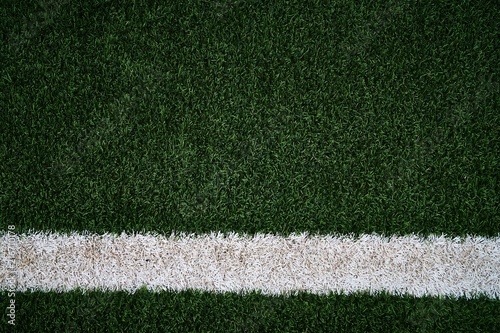 Artificial green grass football / soccer field / pitch & white stripe - close up